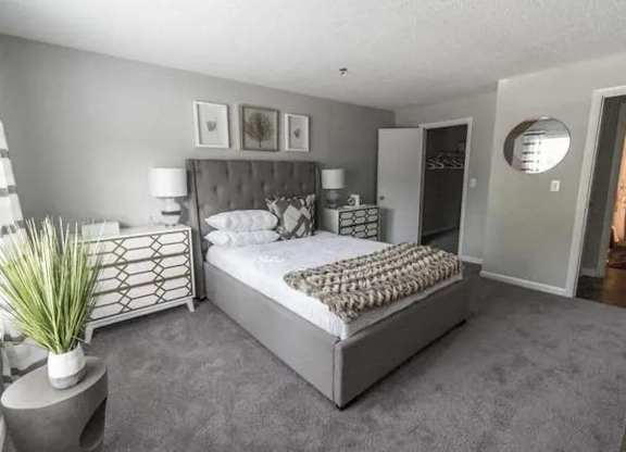 a bedroom with a large bed and a mirror at The Sapphire, Georgia