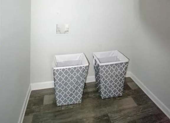a bathroom with two baskets on the floor at The Sapphire, Decatur, GA