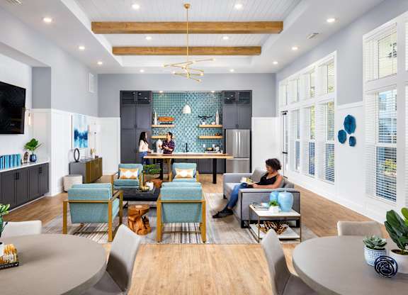 a living room filled with furniture and a kitchen at Century Mundy Mill Apartments, Oakwood, GA 30566