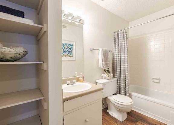 A white bathroom with a toilet, sink, and shower. at Grove at St. Andrews, Columbia, SC, 29210