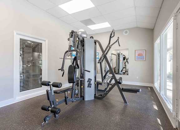 A well-equipped gym with a variety of machines and weights. at Grove at St. Andrews, Columbia, 29210
