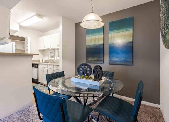 A dining room with a glass table and chairs. at Grove at St. Andrews, Columbia, South Carolina