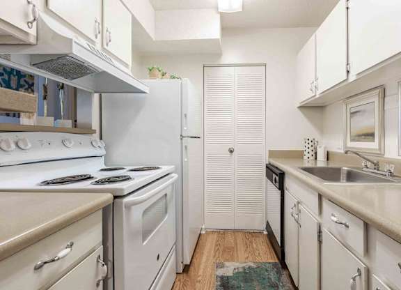 A kitchen with white appliances and cabinets. at Grove at St. Andrews, Columbia, SC, 29210
