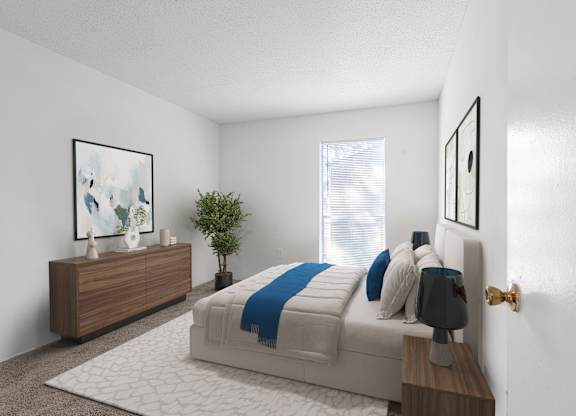A bedroom with a bed, nightstand, and a plant. at Grove at St. Andrews, Columbia, SC
