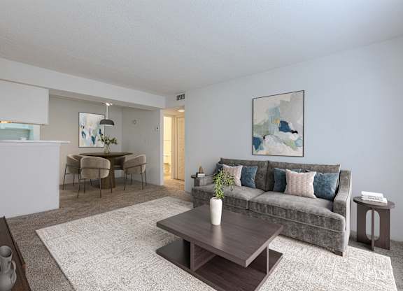 A living room with a grey couch and a coffee table in the middle. at Grove at St. Andrews, Columbia, 29210