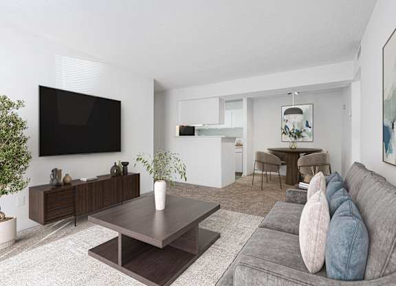 A modern living room with a grey couch and a wooden coffee table. at Grove at St. Andrews, South Carolina