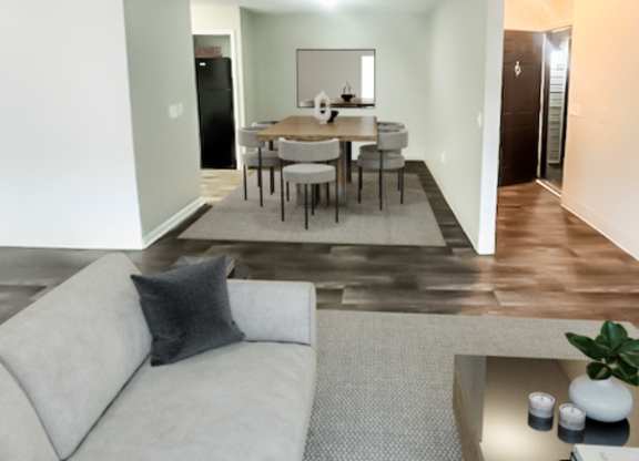a living room and dining room with a couch and a table