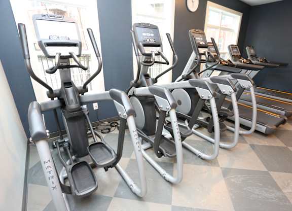 a row of exercise bikes in a gym at Century Baxter Avenue, Louisville Kentucky