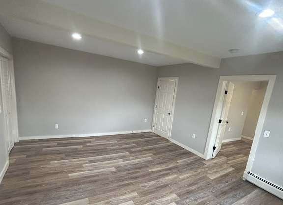 a living room with wood flooring and gray walls at Briarcliff at Quechee Apartments, Quechee