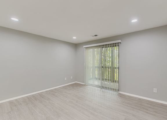 A room with a sliding glass door and light grey walls at Keita 1875, College Park, GA