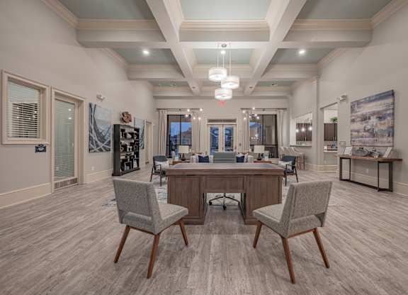a clubhouse with a large table and chairs in the center of it at Century HomePlace, Prattville