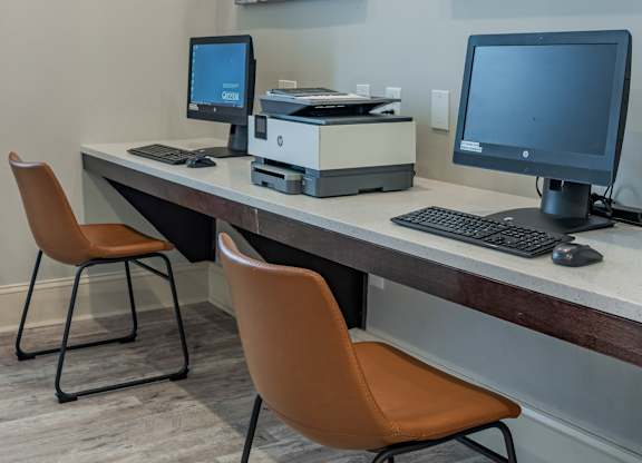 a computer desk with two monitors and two chairs at Century HomePlace, Prattville, AL 36066