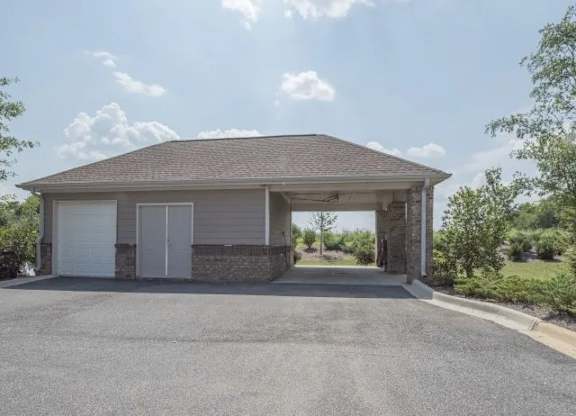 a garage with a roof and a driveway at Century HomePlace, Prattville, 36066