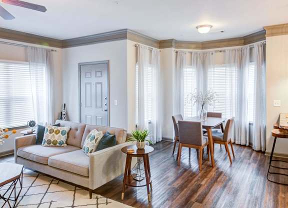 a living room and dining room with a couch and a table at Century HomePlace, Prattville Alabama