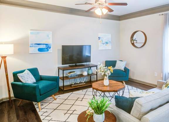 a living room with a couch and a tv at Century HomePlace, Alabama