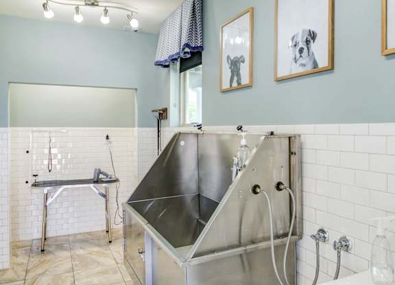 a large stainless steel sink in a bathroom with a shower at Century HomePlace, Prattville Alabama