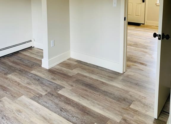 a living room with wood floors and a white door at Briarcliff at Quechee, Quechee, 05059