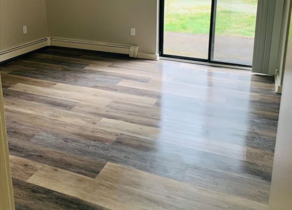 a living room with wood floors and a sliding glass door at Briarcliff at Quechee, Quechee Vermont