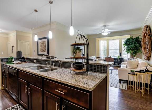 a kitchen with an island and a living room at Century Lakeshore Crossings, Birmingham