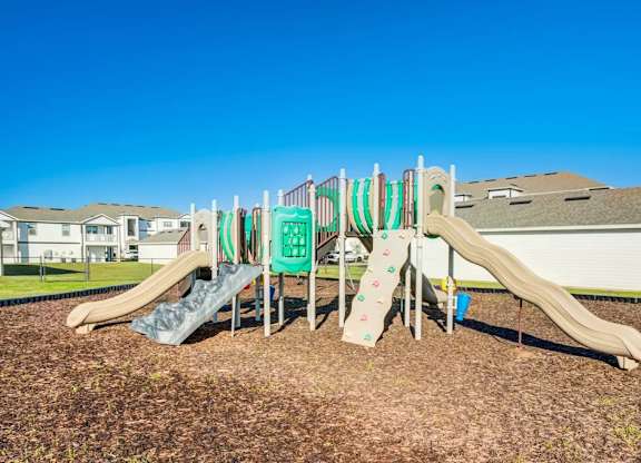 A playground with a green slide and a brown slide.at Century Ariva, Lakeland, 33812