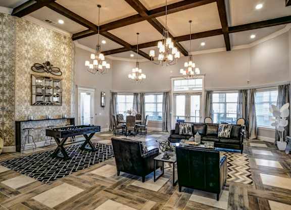 A living room with a black and white checkered rug and a wooden floor.at Century Ariva, Lakeland, 33812