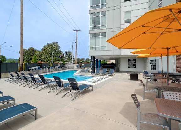 A pool area with sun loungers and umbrellas.at Century Bridges, Roanoke Virginia