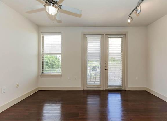 A room with a ceiling fan and sliding glass doors.at Century Cedar Hill, Cedar Hill, TX 75104