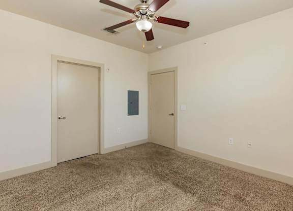 A room with a ceiling fan and carpeted floor.at Century Cedar Hill, Texas, 75104
