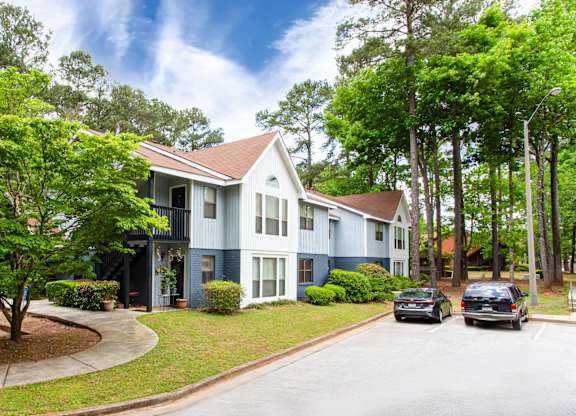 Two story apartment building exterior with parking at Salem Glen Apartments, Conyers, GA