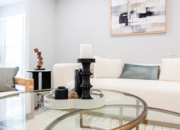 A modern living room with a glass coffee table and a white sof at Keita 1875, College Park
