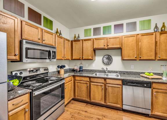 A kitchen with wooden cabinets and stainless steel appliances.