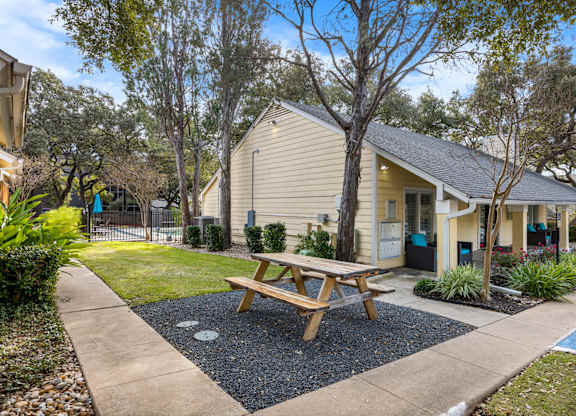A small house with a picnic table in front.