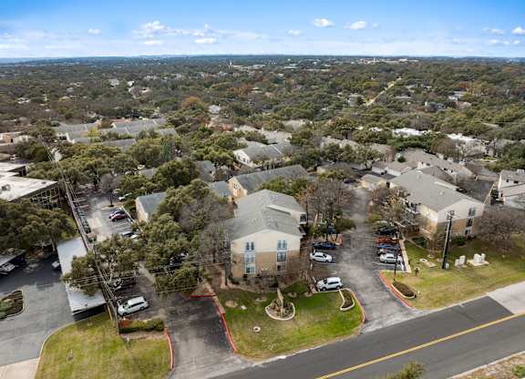 A bird's eye view of a residential area with houses and cars.