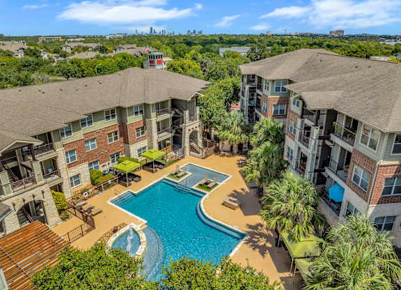 A swimming pool surrounded by apartment buildings.