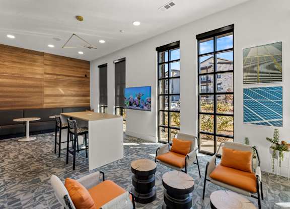 A room with a white table and orange chairs. at Bridge at Tech Crossing, Austin, 78753