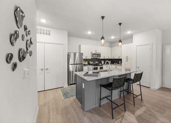 A kitchen with a white counter and a sink. at Bridge at Tech Crossing, Austin, 78753