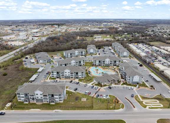 A large residential complex with a swimming pool and a roundabout.