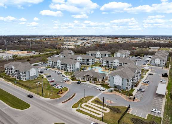 A view of a housing complex with a road running through it.