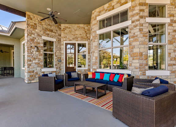 A patio with a couch and chairs. at Bridge at Indigo, Texas, 78717