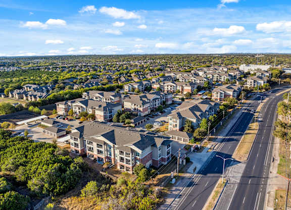 A bird's eye view of a residential area with houses and roads. at Bridge at Southpark Meadows, Austin, Texas