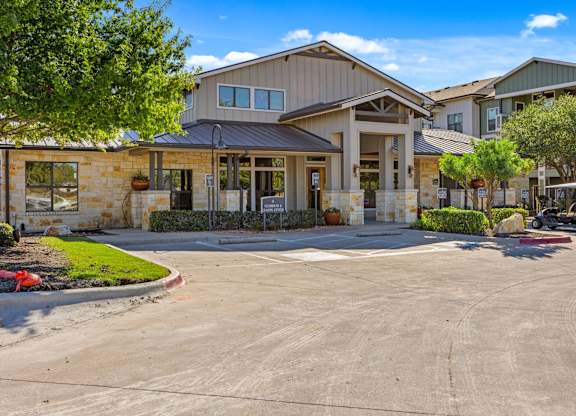 A large building with a parking lot in front. at Bridge at Southpark Meadows, Austin