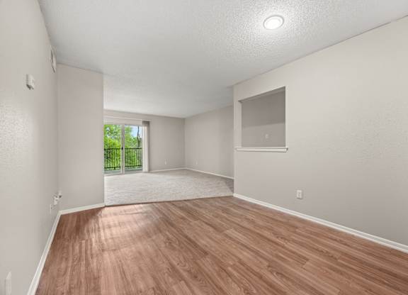A room with wooden flooring and white walls. at Montecito, Austin