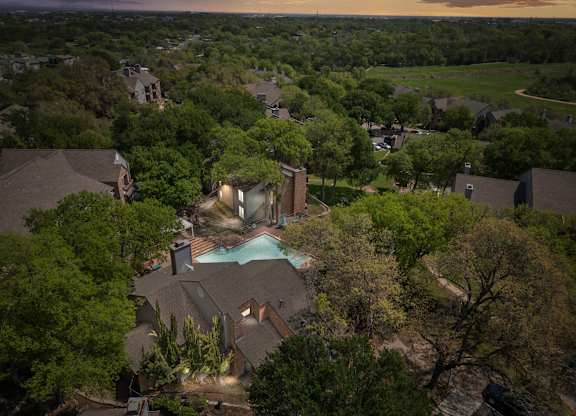 A house with a pool surrounded by trees. at Montecito, Texas, 78741