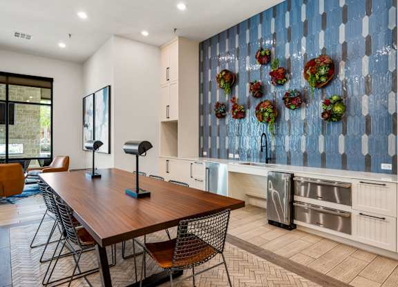 A kitchen with a wooden table and chairs. at The Haywood Apartments, Texas, 78748
