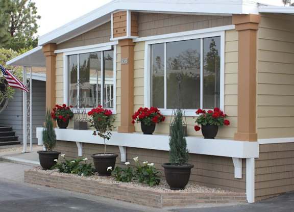 a house with red flowers in front of it