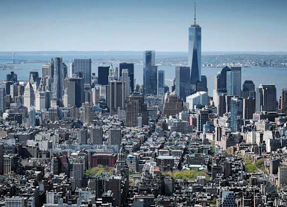 A cityscape with a clear blue sky above.