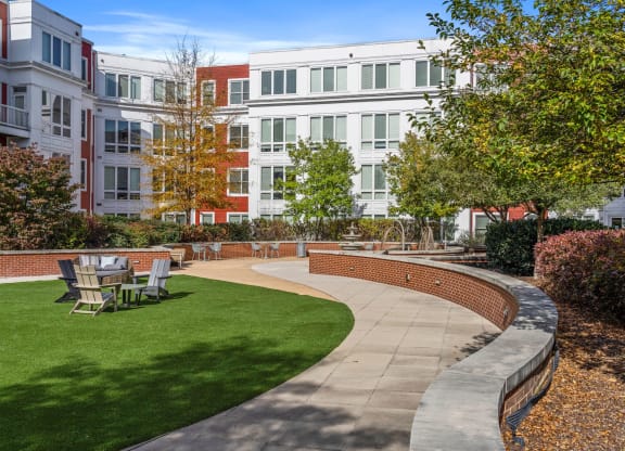 a courtyard with a seating area and grass