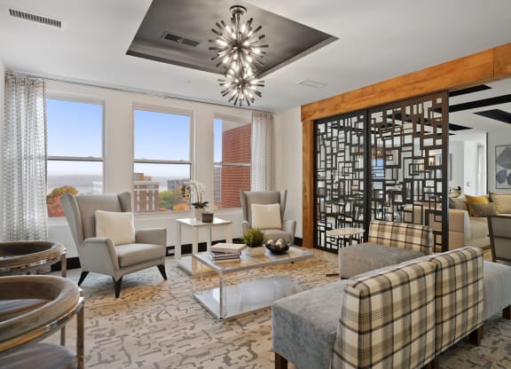 a living room with couches and chairs and a chandelier