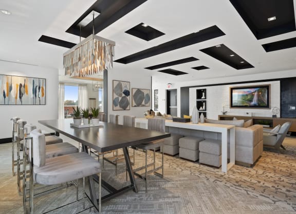 a dining room and living room with a long table and chairs