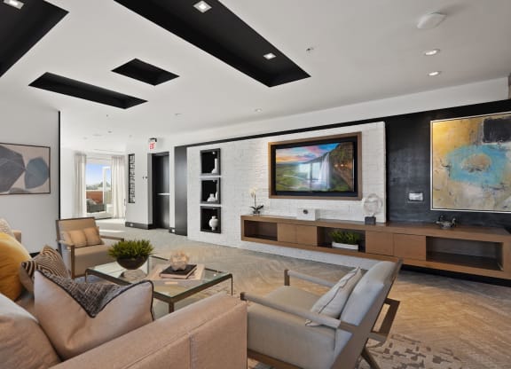 a living room with a couch and chairs and a television
